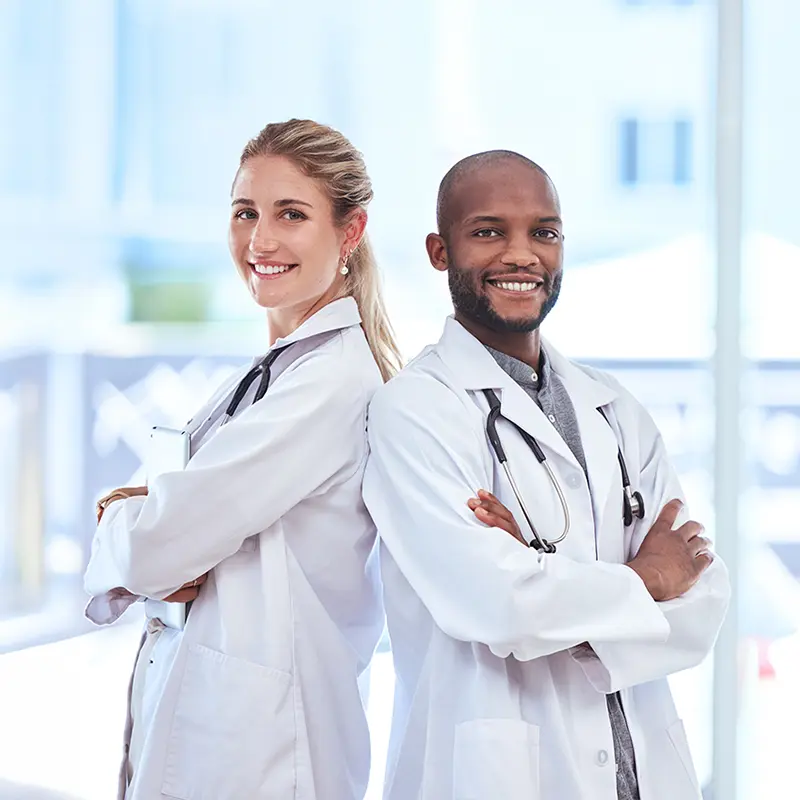 Two doctors crossing arms smiling